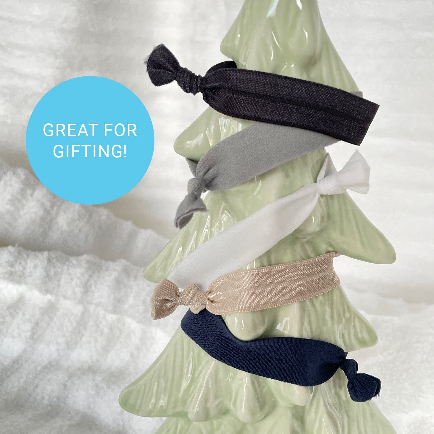 Five hair ties on a ceramic holiday tree.